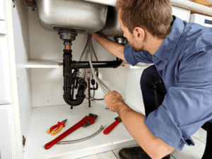 plumber fixing sink